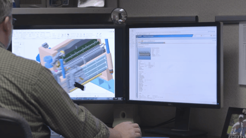Employee working on project using Windchill software