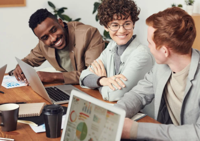 Group of colleagues smiling whilst working